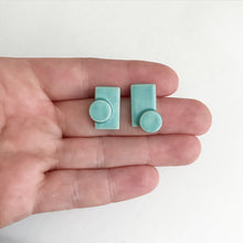 Load image into Gallery viewer, Handmade, 3 dimensional ceramic stud earrings. Rectangle + circle earrings with seafoam coloured glaze.
