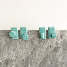 Load image into Gallery viewer, Handmade, 3 dimensional ceramic stud earrings. Rectangle earrings with seafoam coloured glaze.
