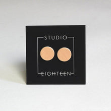 Load image into Gallery viewer, Circle, ceramic stud earrings with peach glaze.
